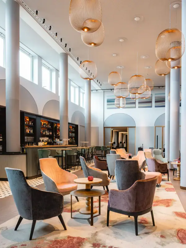 Ein Zimmer mit Stühlen und Tischen, im Innenbereich gestaltet mit Möbeln.