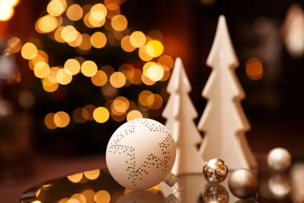 Weißer Weihnachtsbaum mit Kugeln und Ornamenten.