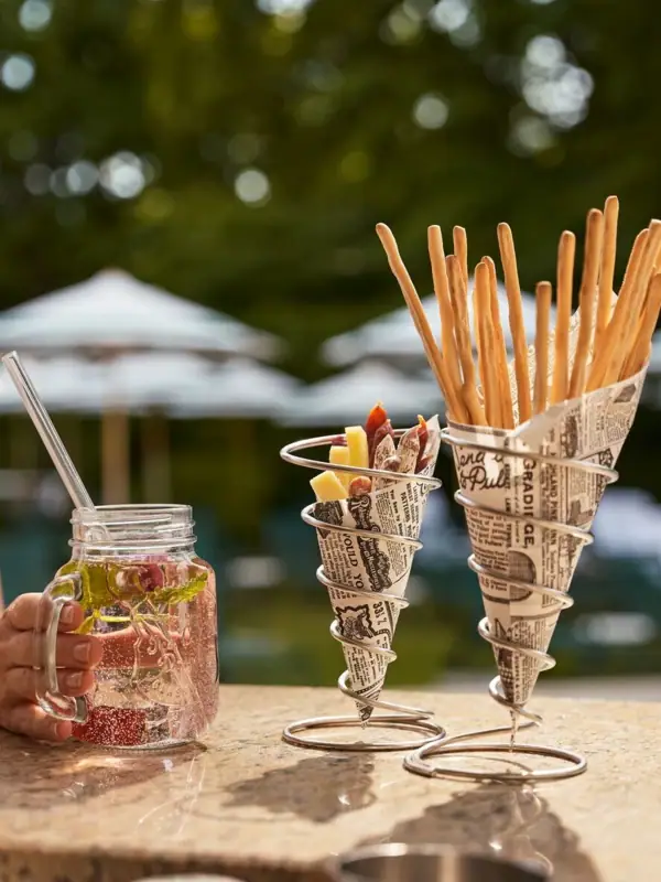 Ein Paar Strohhalme in einem Glas Wasser auf einem Tisch.