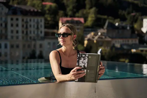 Außenpool Eine Frau liest ein Buch in einem Schwimmbecken.