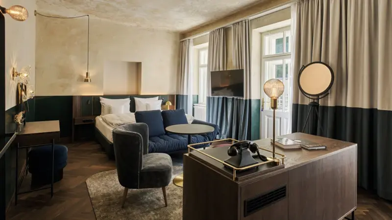 Zimmer & Suiten in Bad Gastein Ein Zimmer mit einem Bett und einem Sofa.