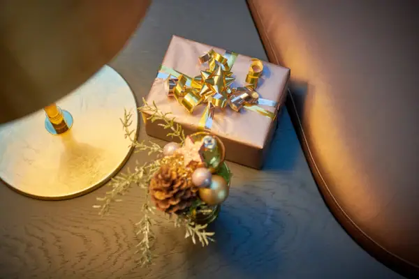 Geschenk Geschenkbox mit Schleife und Tannenzapfen auf einem Tisch