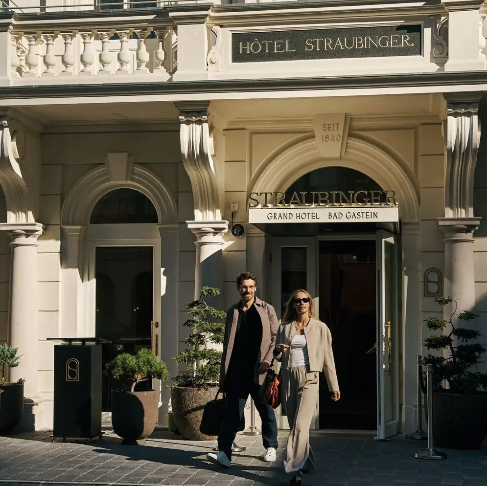 Ein Paar bereit, die Welt zu erobern Man und Frau verlassen ein Haus mit Gepäckstücken