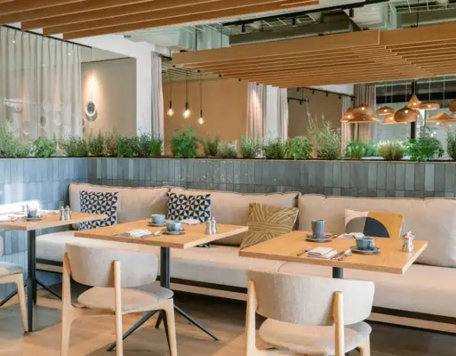 Restaurant im A-ROSA Gardasee Ein Restaurant mit Tischen und Stühlen im Innenbereich.