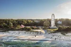 Strand Riesenrad am Strand vor blauem Himmel und Wasser im Hintergrund.