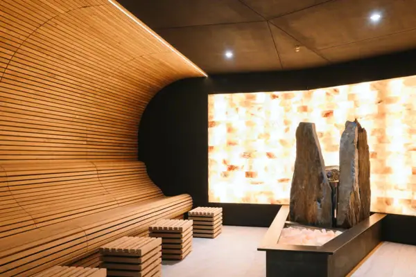 Ein Raum mit einer Bank und Steinen, im Hintergrund eine Statue.