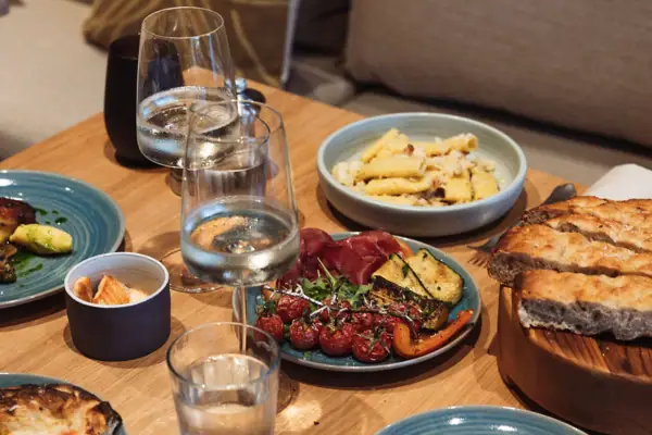 Ein Tisch mit Tellern voller Essen und Gläsern mit Wasser.