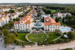 A-ROSA Ostseehotel Kühlungsborn Eine große Gruppe von Gebäuden mit einem Pool und Bäumen.